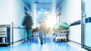 Doctors or nurses walking in hospital hallway, blurred motion